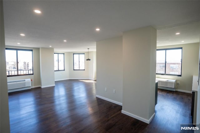 unfurnished room with recessed lighting, baseboards, and dark wood-style floors