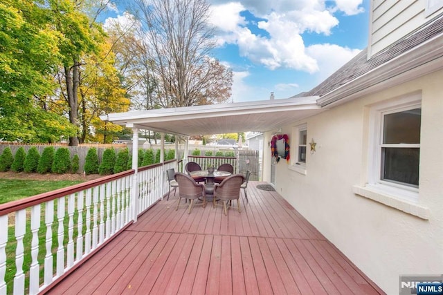 wooden terrace featuring fence and outdoor dining space