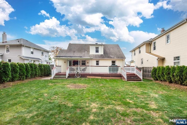 back of property featuring a yard, a fenced backyard, and a wooden deck