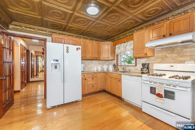 kitchen featuring an ornate ceiling, white appliances, a sink, and under cabinet range hood