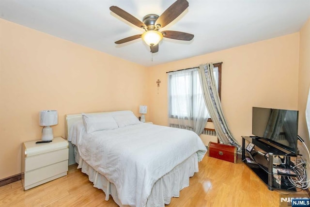 bedroom with light wood-type flooring and a ceiling fan