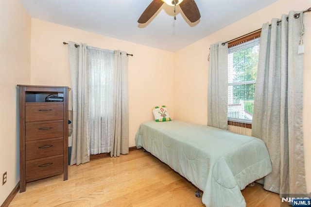 bedroom with light wood-style floors and a ceiling fan