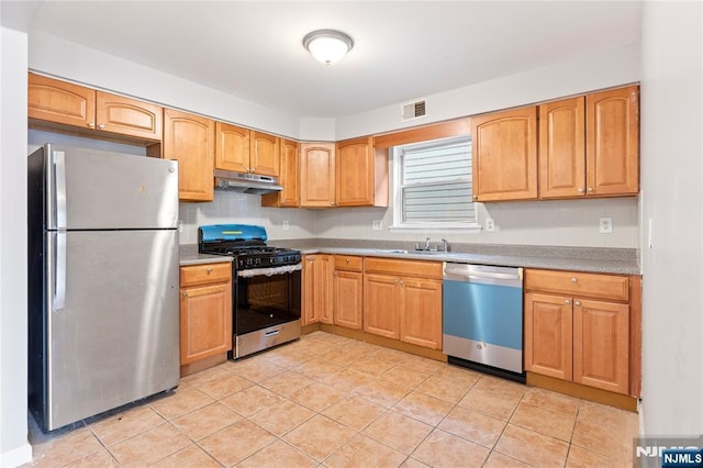 kitchen with light tile patterned floors, stainless steel appliances, visible vents, a sink, and under cabinet range hood