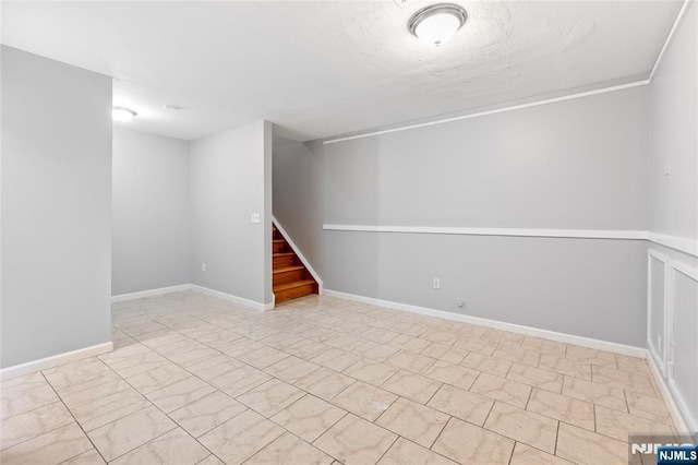 below grade area with stairway and baseboards