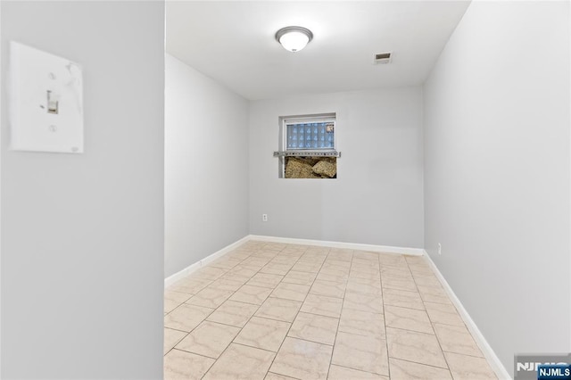 spare room featuring visible vents and baseboards