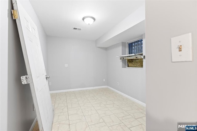 interior space with marble finish floor, visible vents, and baseboards