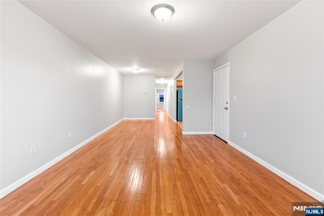 empty room featuring light wood-style floors and baseboards