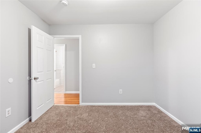 carpeted empty room with baseboards