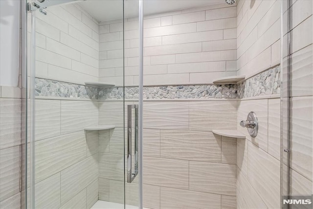 bathroom with a shower stall