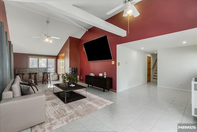 living area with beam ceiling, high vaulted ceiling, baseboards, ceiling fan, and stairs