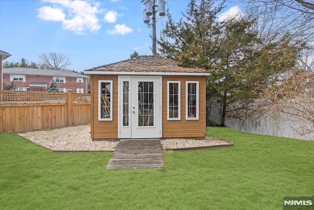 view of outbuilding featuring an outdoor structure and fence