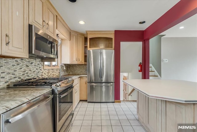 kitchen with open shelves, stainless steel appliances, light brown cabinetry, and light countertops