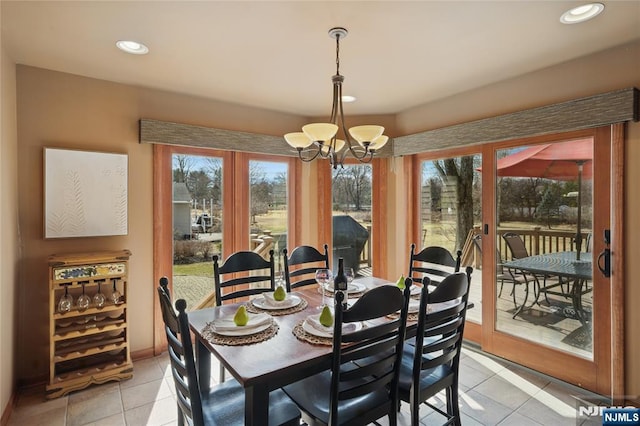 dining space featuring recessed lighting, light tile patterned floors, baseboards, and an inviting chandelier