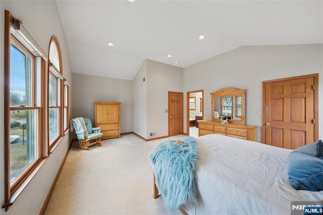 bedroom with light carpet, multiple windows, baseboards, and vaulted ceiling