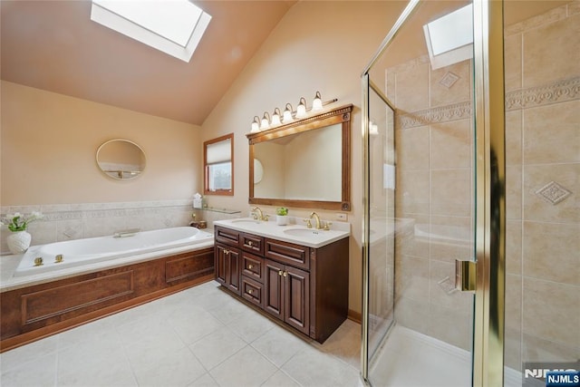 bathroom with vaulted ceiling with skylight, a sink, and a shower stall