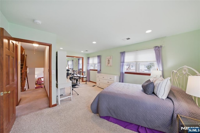 bedroom featuring recessed lighting, light colored carpet, and visible vents