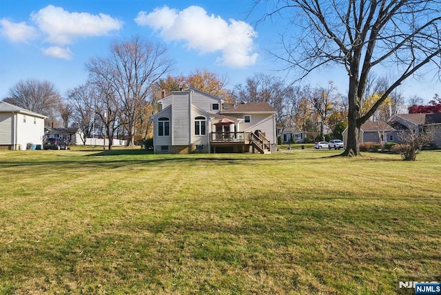 view of yard with stairway and a wooden deck