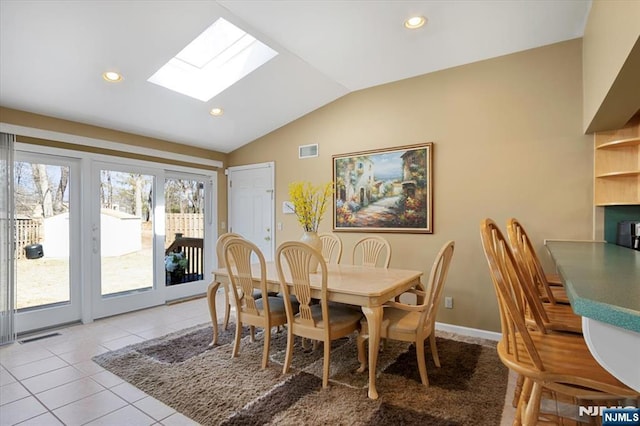 dining room with light tile patterned floors, recessed lighting, visible vents, baseboards, and lofted ceiling with skylight