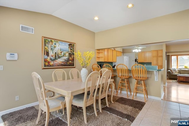 dining room with lofted ceiling, light tile patterned floors, baseboards, and visible vents