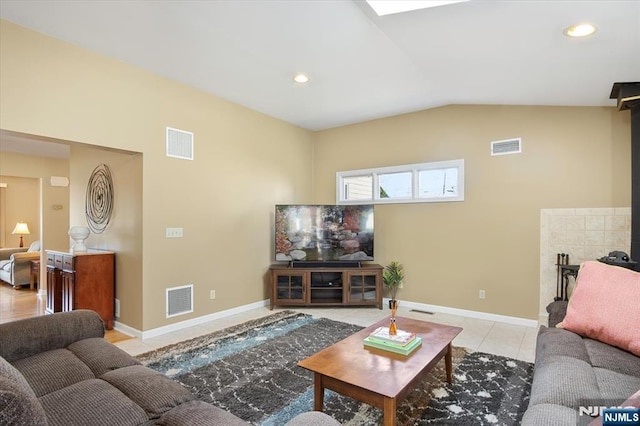 living room featuring vaulted ceiling, light tile patterned floors, visible vents, and baseboards