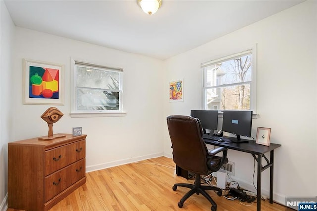 office space featuring light wood-type flooring and baseboards