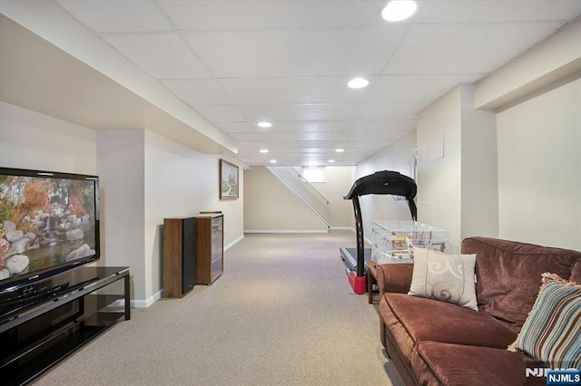 carpeted living area with baseboards, a drop ceiling, and recessed lighting