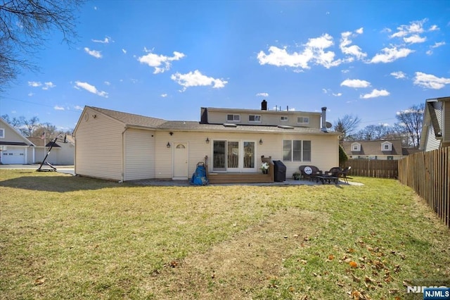 rear view of property with a lawn, a patio, and fence