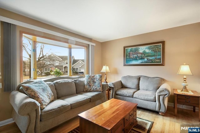 living room with wood finished floors and baseboards