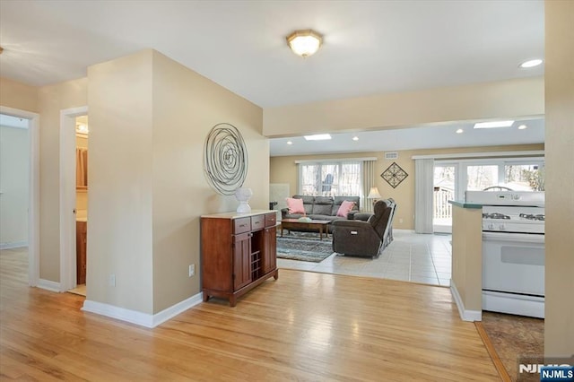 interior space with recessed lighting, baseboards, and light wood finished floors