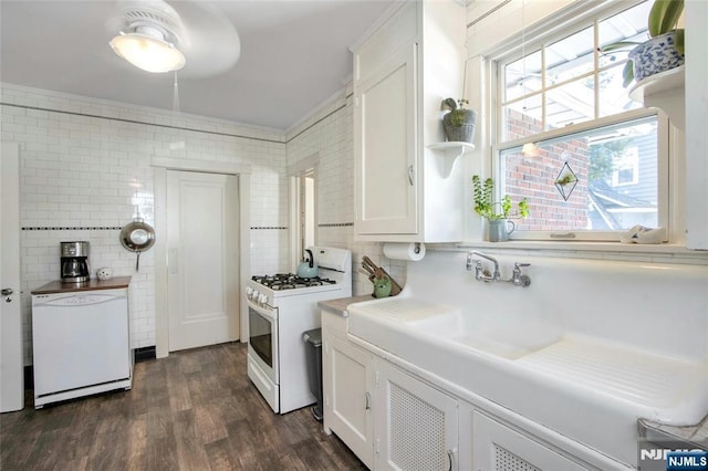 kitchen with white appliances, dark wood-style flooring, light countertops, white cabinetry, and tasteful backsplash