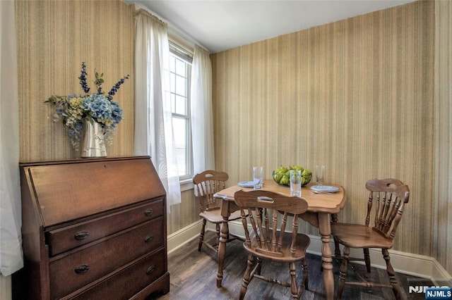 dining area featuring baseboards, dark wood-style flooring, and wallpapered walls