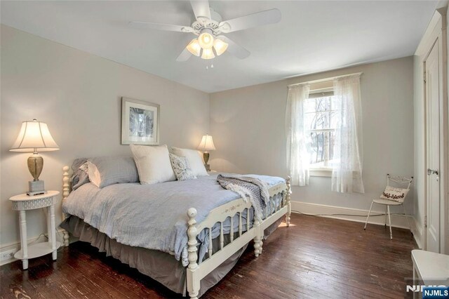 bedroom featuring a ceiling fan, baseboards, and wood-type flooring