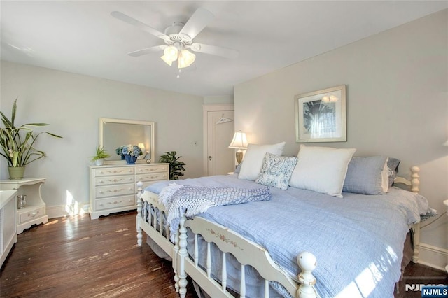 bedroom featuring ceiling fan, dark wood-type flooring, and baseboards