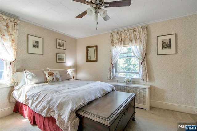 bedroom featuring light carpet, ornamental molding, radiator heating unit, and wallpapered walls