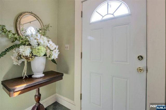 foyer entrance featuring baseboards