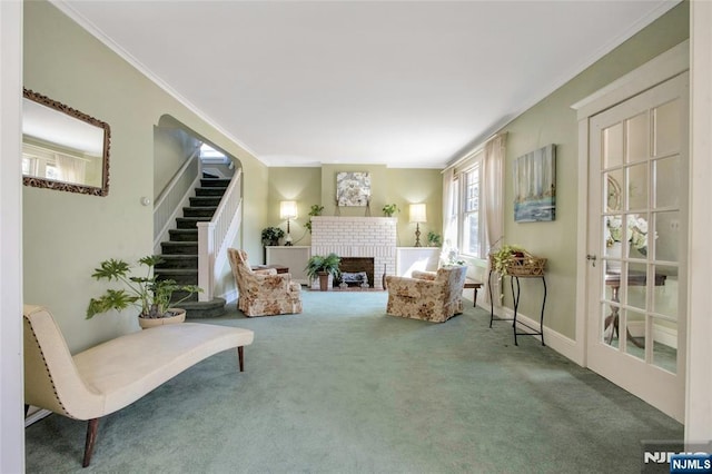 sitting room featuring ornamental molding, stairway, a fireplace, carpet flooring, and baseboards