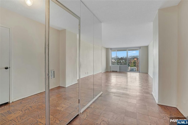 empty room featuring visible vents and floor to ceiling windows