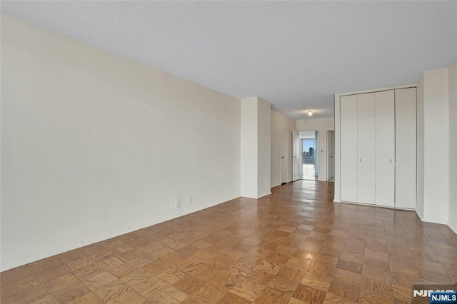 empty room featuring a textured ceiling