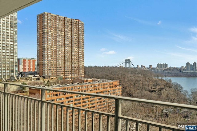 balcony featuring a city view and a water view