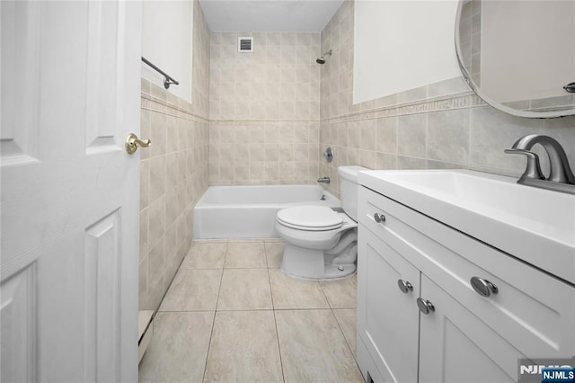 full bathroom featuring visible vents, toilet, vanity, shower / bathing tub combination, and tile walls