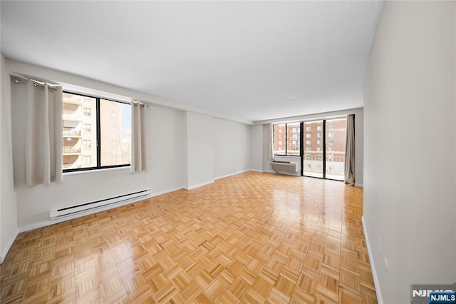 spare room featuring baseboards and baseboard heating