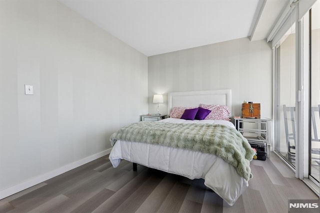 bedroom with baseboards and wood finished floors