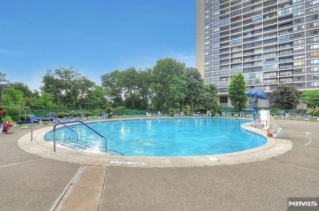 pool featuring a patio and fence