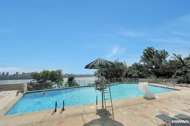 pool featuring a patio area and fence