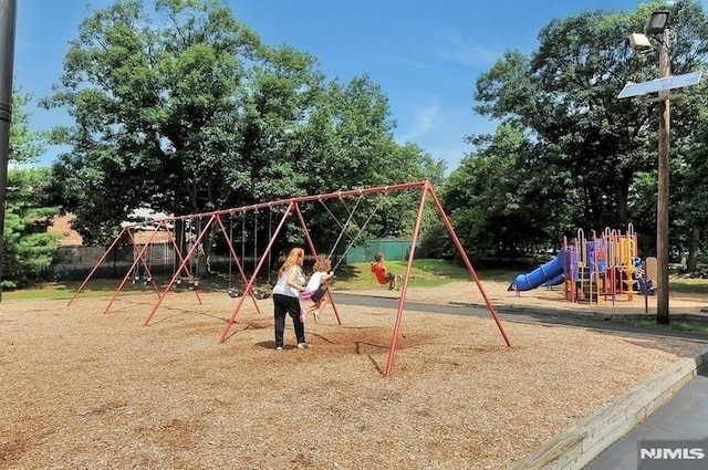 communal playground featuring fence