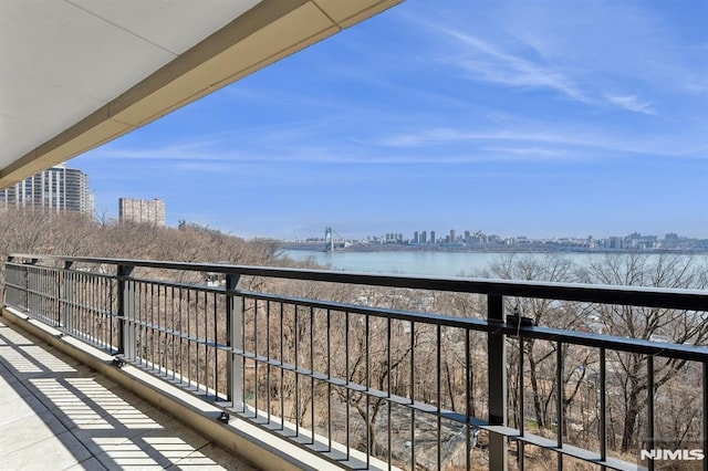 balcony featuring a view of city and a water view