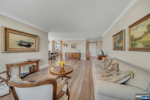 living area featuring light wood-type flooring, baseboards, and ornamental molding