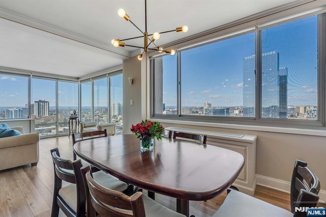 dining area featuring a view of city, a healthy amount of sunlight, and a chandelier