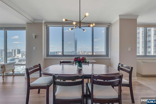 dining room with a wealth of natural light, a view of city, and ornamental molding