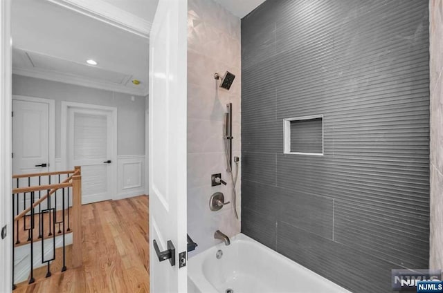 full bathroom with shower / washtub combination, crown molding, and wood finished floors